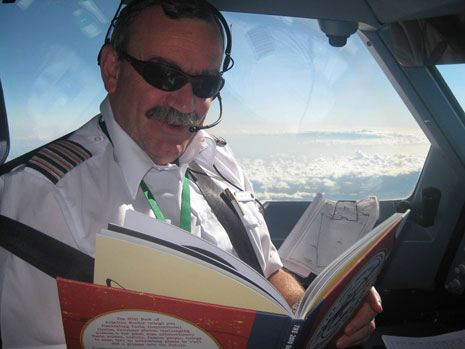 Here's Bob himself reading the book in the cockpit with Mount Kenya in the background.