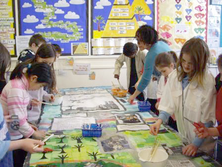 Pupils making a large-scale collage with artist Gloria Ojulari Sule.