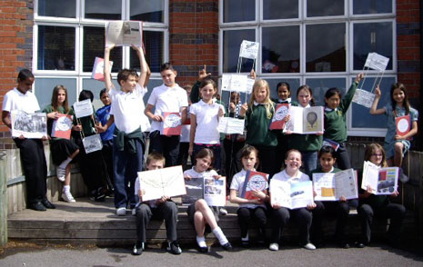 In this photo the pupils are holding up copies of their books and also some of the boxkites they have made for a special event to mark the centenary of the first flight of the Bristol Boxkite aeroplane. Bill Morgan, who has helped them make the boxkites, was at the special school assembly on 2 July.