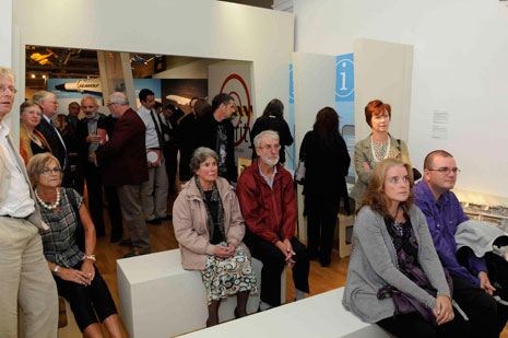 Guests at the evening reception watch some of the film material.