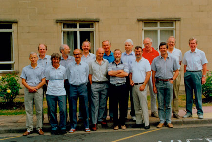 The colour photograph shows the class reunited in 1990.